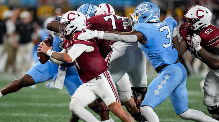 North Carolina's Kaimon Rucker and Amari Gainer sack South Carolina QB Spencer Rattler.